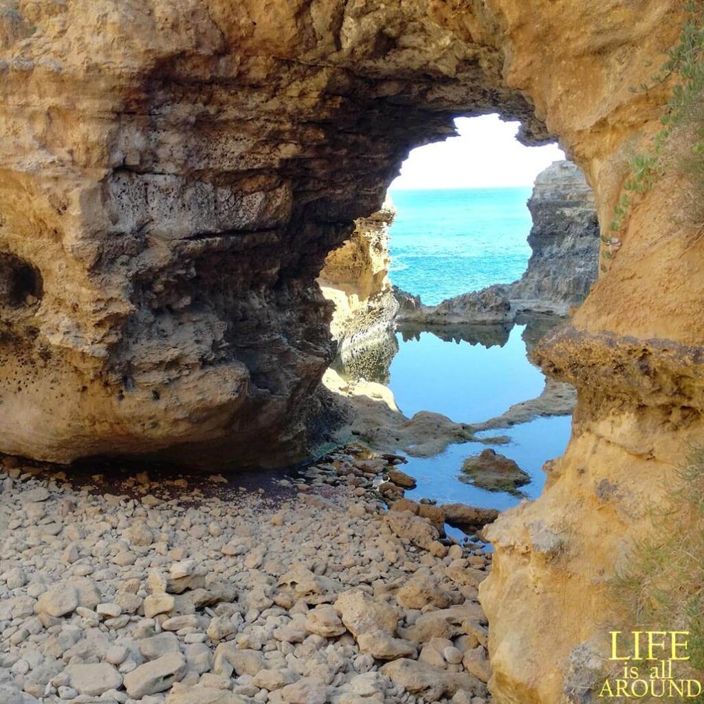 This shows a cave and the sea below, in Great Ocean Road Melbourne 2018