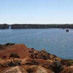 A photo from the Great Ocean Road showing the view from the water in a rocky environment that looks as if the water is trapped in it.